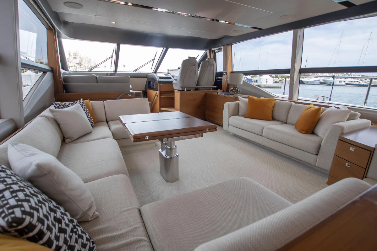Luxurious interior of a 2015 Princess 68 yacht with elegant seating and panoramic windows.
