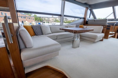 Luxurious interior of a 2015 Princess 68 yacht with elegant seating and modern decor.