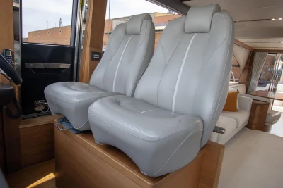 Luxurious interior of 2015 Princess 68 yacht with plush gray seating.