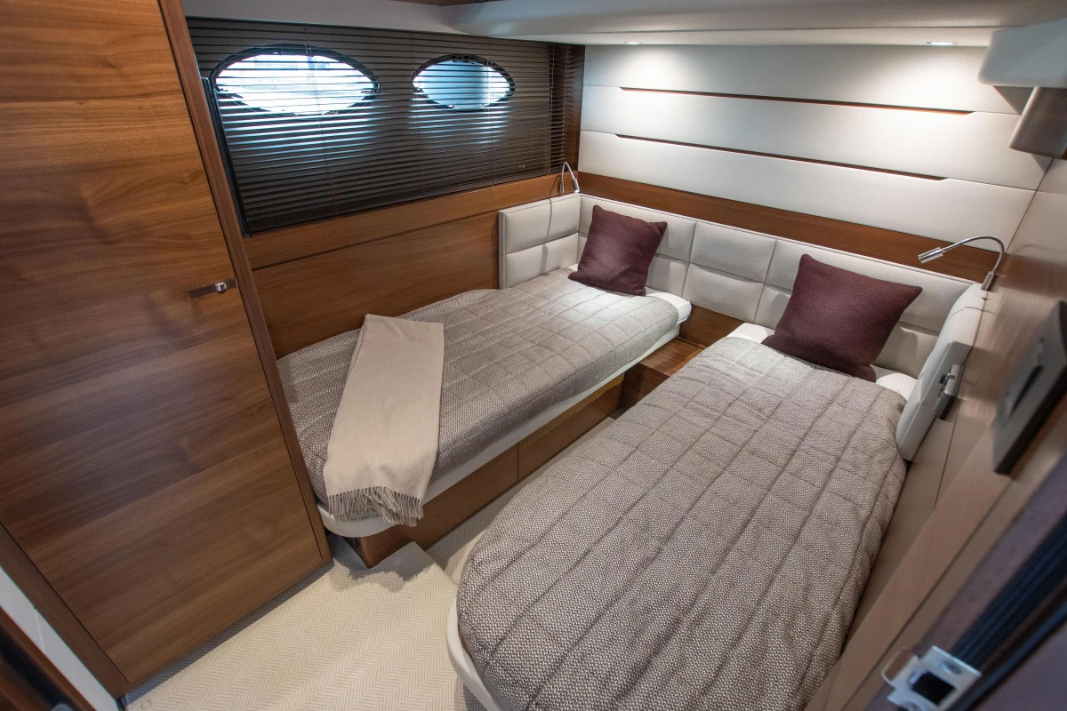 Luxurious twin cabin interior of 2015 Princess 68 yacht with modern design elements.