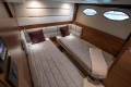Luxurious cabin interior of 2015 Princess 68 yacht with twin beds and elegant decor.