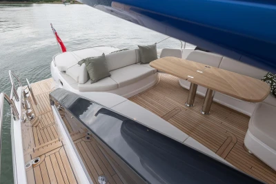 Luxurious 2025 Princess V55 yacht deck with elegant seating and wooden table.