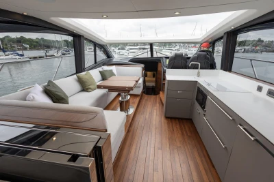 Luxurious interior of 2025 Princess V55 yacht with modern kitchen and seating area.