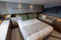 Luxurious bedroom interior of 2025 Princess V55 yacht with modern decor and cozy seating.