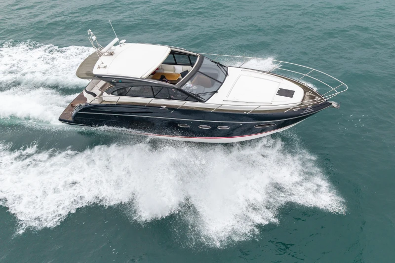 2014 Princess V48 yacht cruising on open sea.