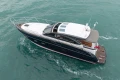 2014 Princess V48 yacht cruising on turquoise waters, aerial view.
