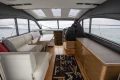 Luxurious interior of 2014 Princess V48 yacht with seating and helm.