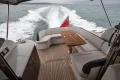 Luxurious 2014 Princess V48 yacht with elegant seating and wooden deck cruising at sea.