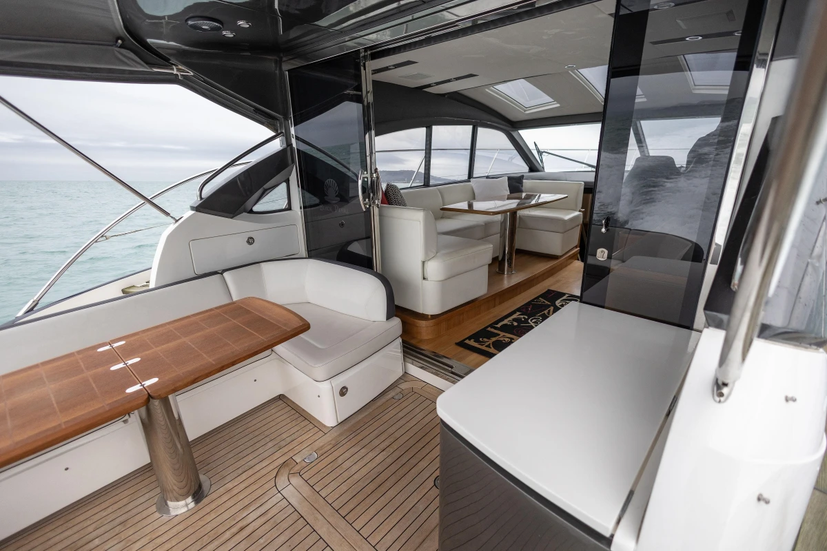 Luxurious interior of 2014 Princess V48 yacht with elegant seating and wooden accents.