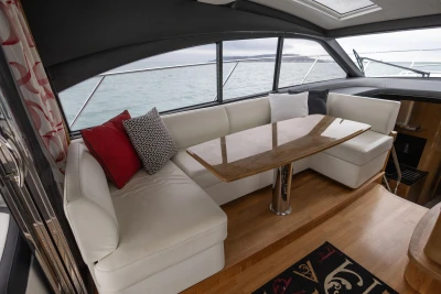 Luxurious interior of 2014 Princess V48 yacht with elegant seating and table.
