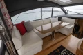 Luxurious interior of 2014 Princess V48 yacht with elegant seating and table.