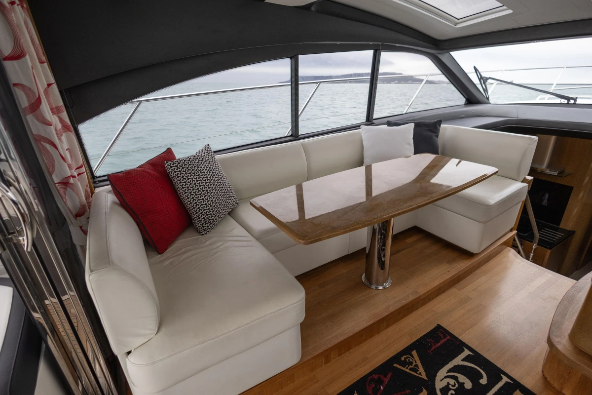 Luxurious interior of 2014 Princess V48 yacht with elegant seating and table.