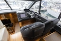 Interior of 2014 Princess V48 yacht cockpit with navigation equipment and leather seating.