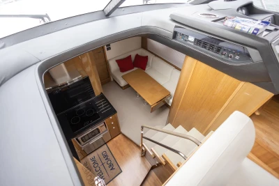 Luxurious interior of 2014 Princess V48 yacht with modern kitchen and cozy seating area.