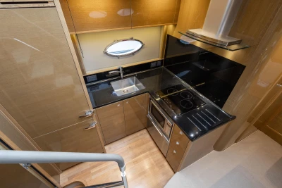 Luxurious kitchen interior of 2014 Princess V48 yacht with modern appliances and sleek design.