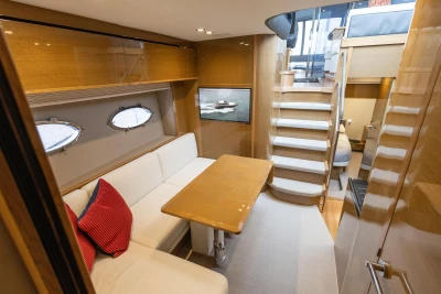 Luxurious interior of 2014 Princess V48 yacht with elegant seating and wooden finishes.