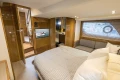 Luxurious interior of 2014 Princess V48 yacht with cozy bedroom and modern amenities.