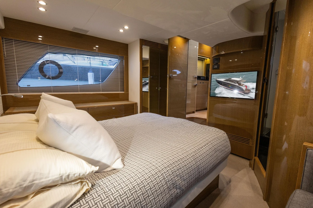 Luxurious interior of 2014 Princess V48 yacht with cozy bedroom and modern amenities.