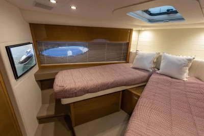 Luxurious 2014 Princess V48 yacht cabin with twin beds and elegant decor.