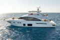 Luxurious 2017 Princess 68 yacht cruising on open sea under clear skies.