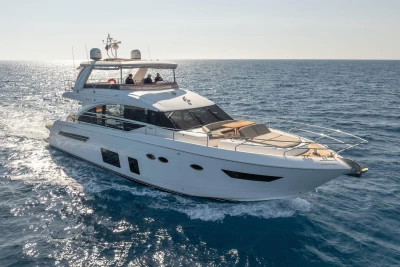 Luxurious 2017 Princess 68 yacht cruising on open sea under clear skies.