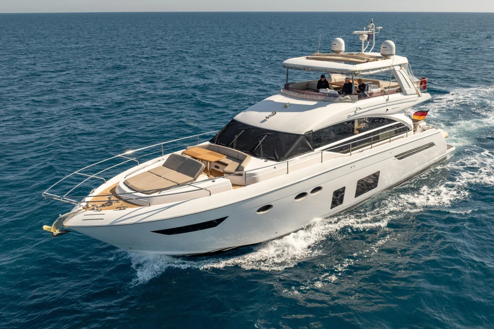 Luxurious 2017 Princess 68 yacht cruising on open sea under clear skies.
