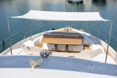 Luxury 2017 Princess 68 yacht deck with seating and canopy on calm water.