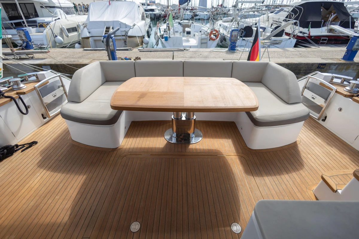 Luxurious 2017 Princess 68 yacht deck with elegant seating and wooden table.