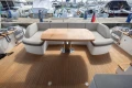 Luxurious 2017 Princess 68 yacht deck with elegant seating and wooden table.