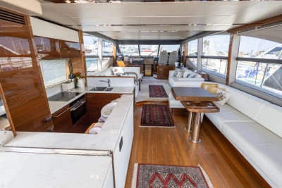 Luxurious interior of 2017 Princess 68 yacht with modern kitchen and spacious seating area.