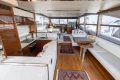 Luxurious interior of 2017 Princess 68 yacht with modern kitchen and spacious seating area.