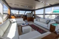 Luxurious interior of a 2017 Princess 68 yacht with elegant white seating and panoramic windows.