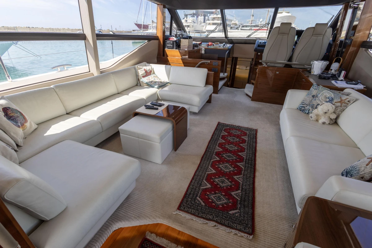 Luxurious interior of a 2017 Princess 68 yacht with elegant white seating and nautical decor.