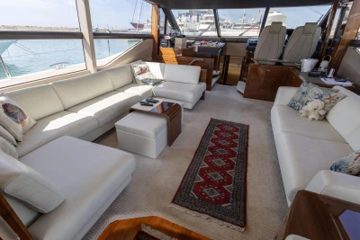 Luxurious interior of a 2017 Princess 68 yacht with elegant white seating and nautical decor.