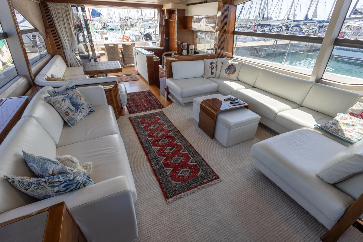 Luxurious interior of 2017 Princess 68 yacht with elegant white seating and nautical decor.