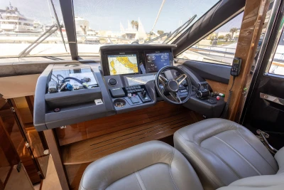 Luxurious 2017 Princess 68 yacht cockpit with modern navigation system and leather seating.