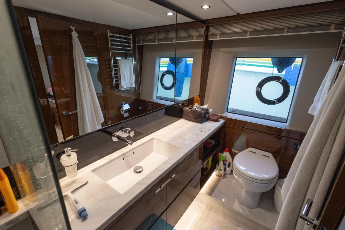 Luxurious bathroom in 2017 Princess 68 yacht with modern fixtures and porthole windows.