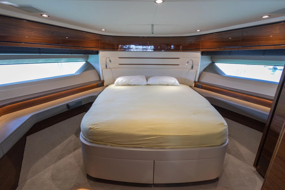 Luxurious bedroom interior of 2017 Princess 68 yacht with elegant wood finishes.