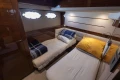 Luxurious cabin interior of 2017 Princess 68 yacht with twin beds and elegant decor.