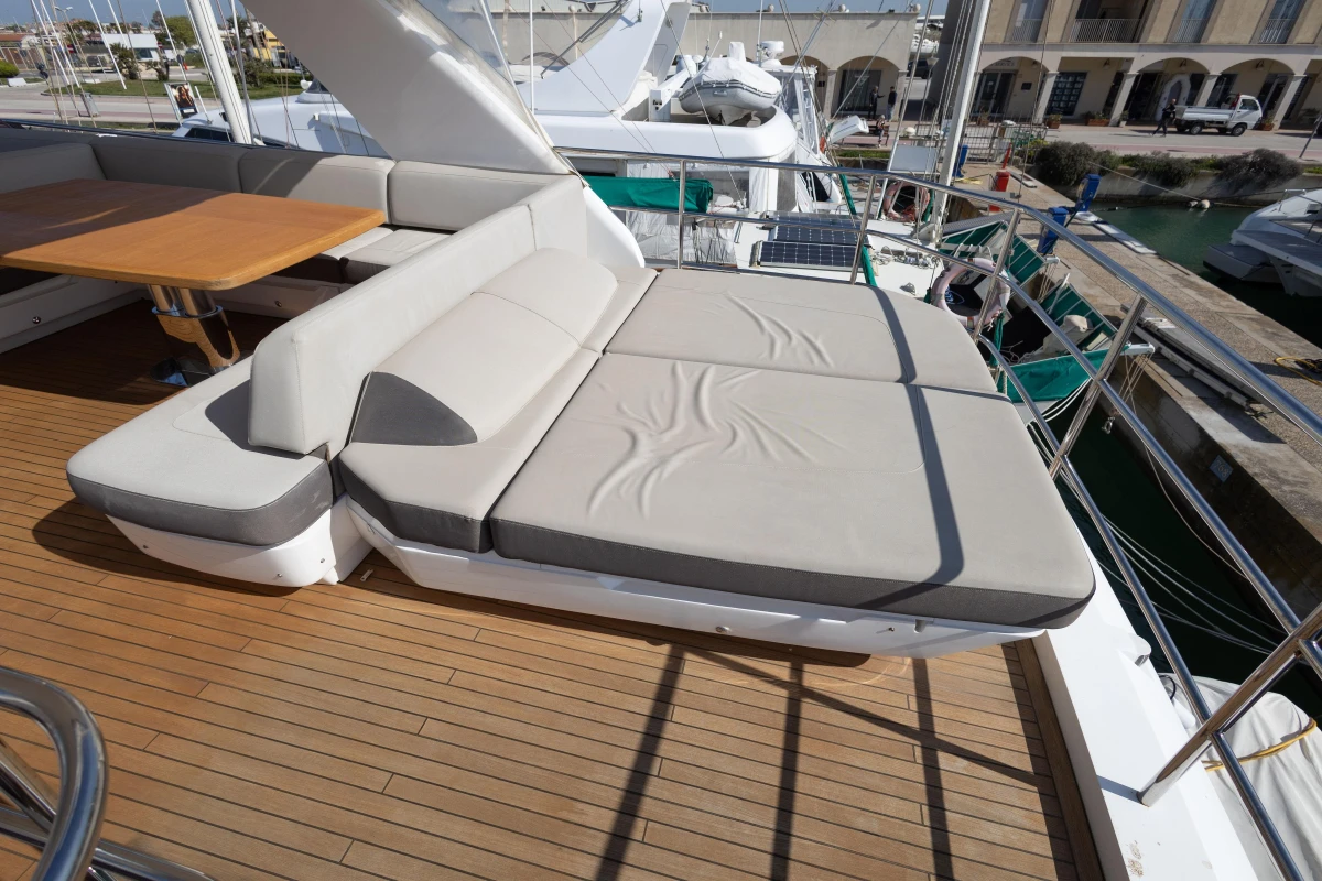Luxurious 2017 Princess 68 yacht deck with sunbed and seating area.
