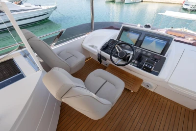 Luxurious helm of 2017 Princess 68 yacht with dual seats and navigation screens.
