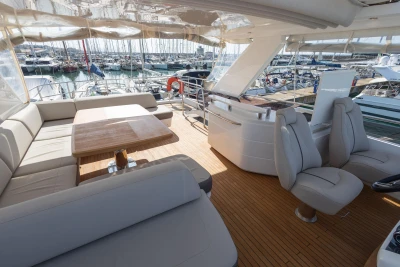 Luxurious 2017 Princess 68 yacht interior with elegant seating and wooden deck.