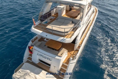 Luxurious 2017 Princess 68 yacht cruising on open sea, featuring spacious deck and elegant design.
