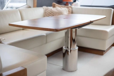 Luxurious interior of 2017 Princess 52 yacht with elegant seating and wooden table.