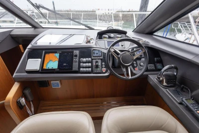 Helm of 2017 Princess 52 yacht with navigation controls and steering wheel.