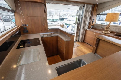 Luxurious 2017 Princess 52 yacht interior with modern kitchen and marina view.