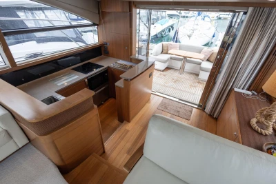 Luxurious 2017 Princess 52 yacht interior with modern kitchen and cozy outdoor seating area.