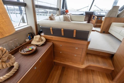 Luxurious interior of 2017 Princess 52 yacht with elegant wood finish and comfortable seating.