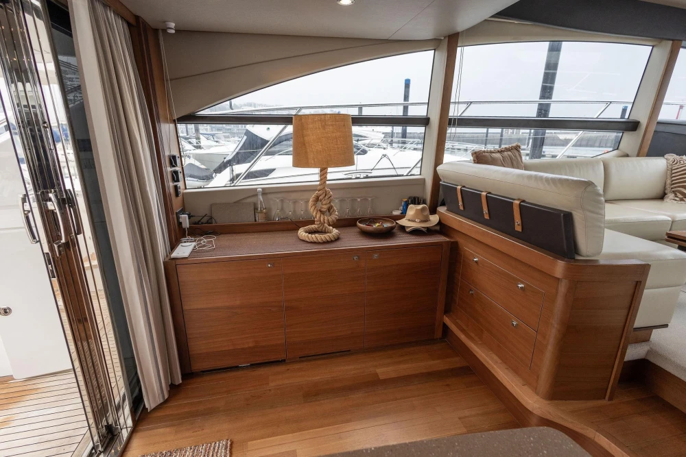 Luxurious interior of 2017 Princess 52 yacht with elegant wood cabinetry and plush seating.