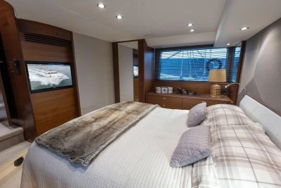 Luxurious bedroom interior of 2017 Princess 52 yacht with elegant decor and modern amenities.